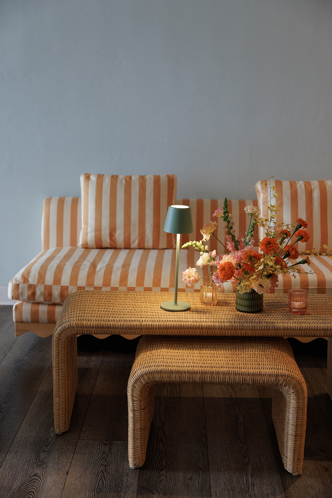 a table with flowers and a lamp on it