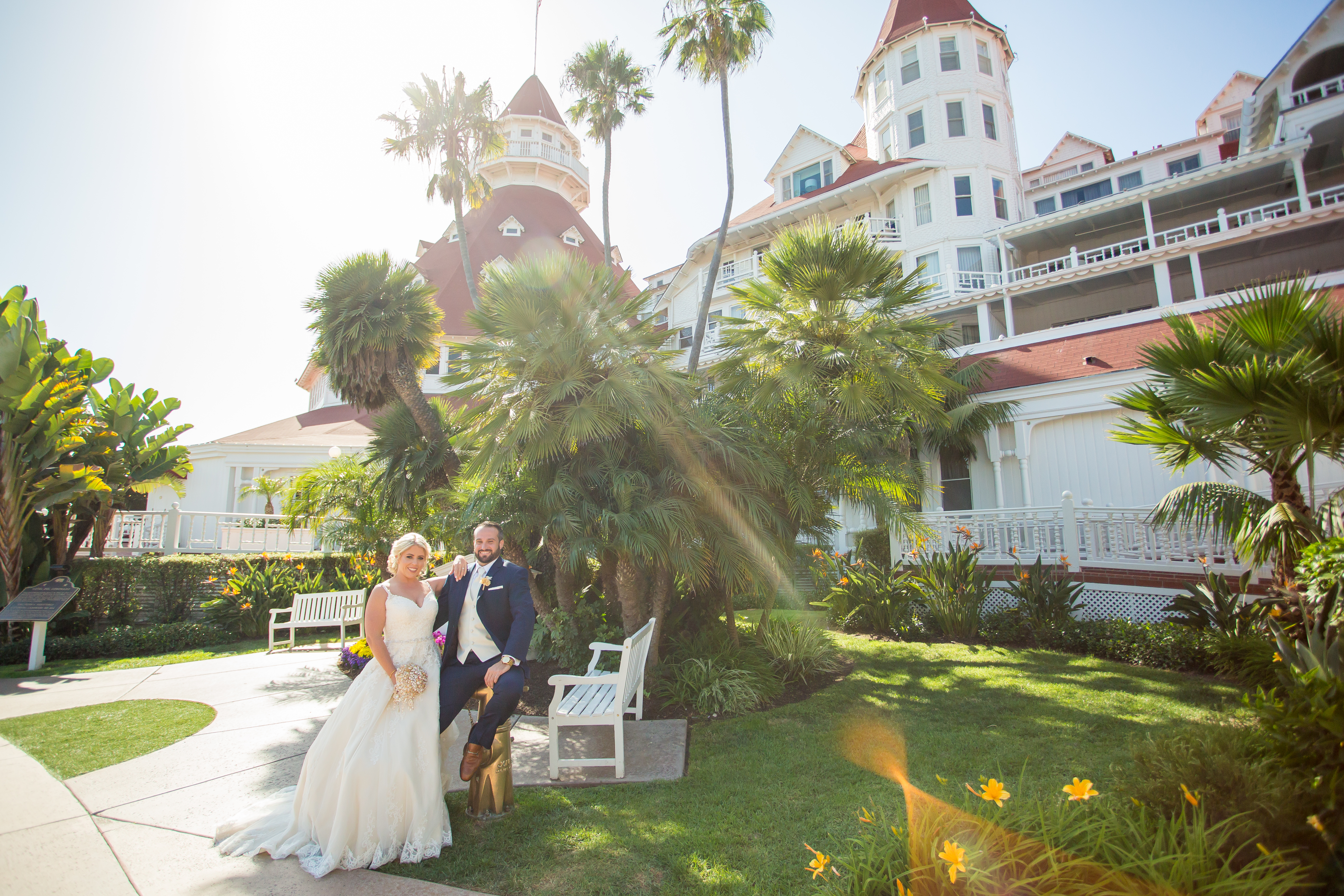 a man and woman posing for a picture in front of a white building