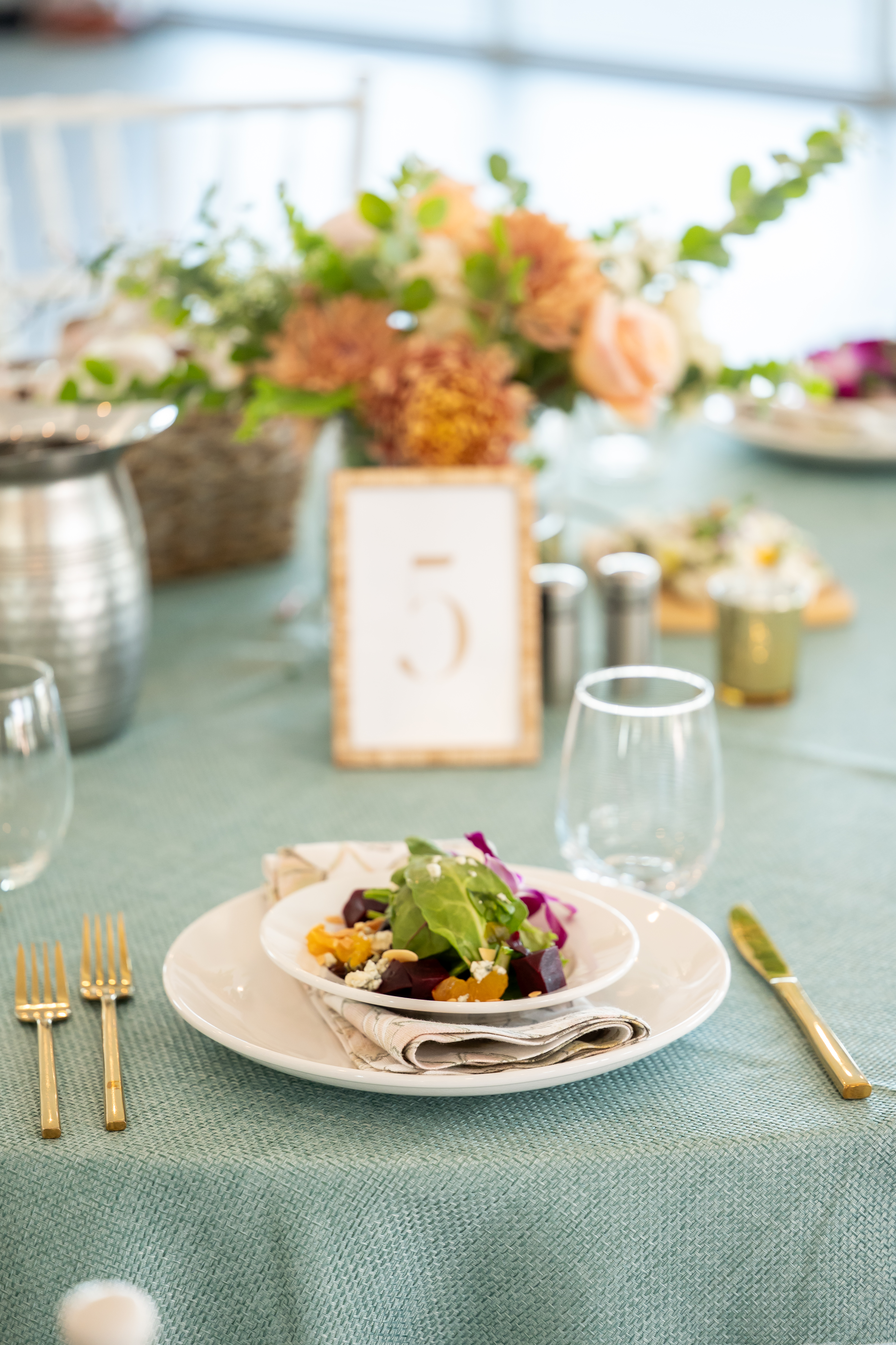 a plate of salad on a table with a number on it
