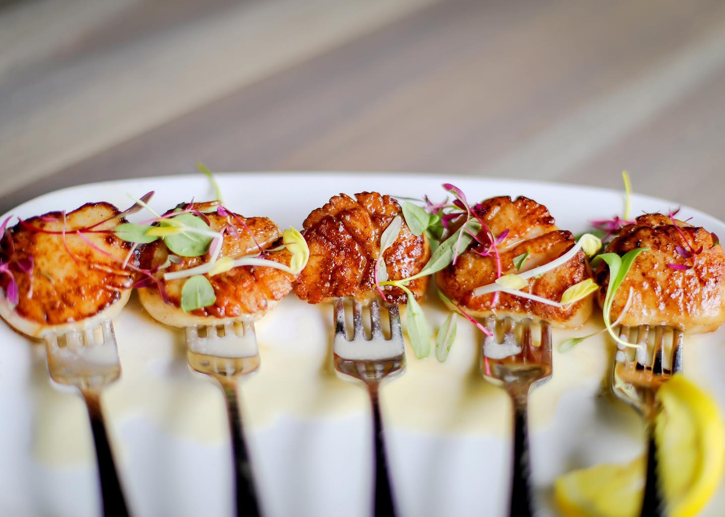 a plate with small meat portions and forks