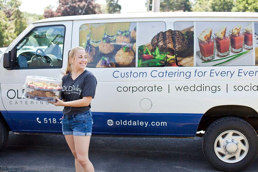 a van with a woman delivering food