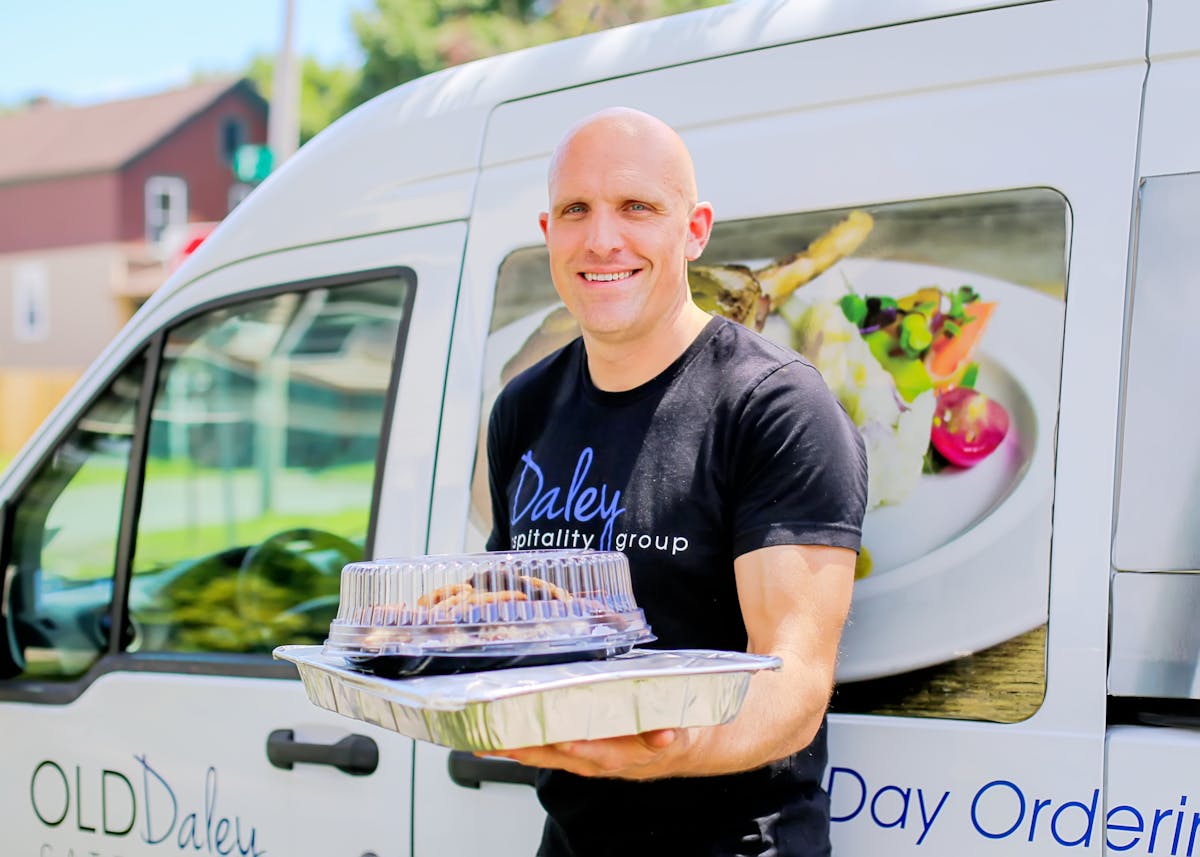 a man holding a tray of food