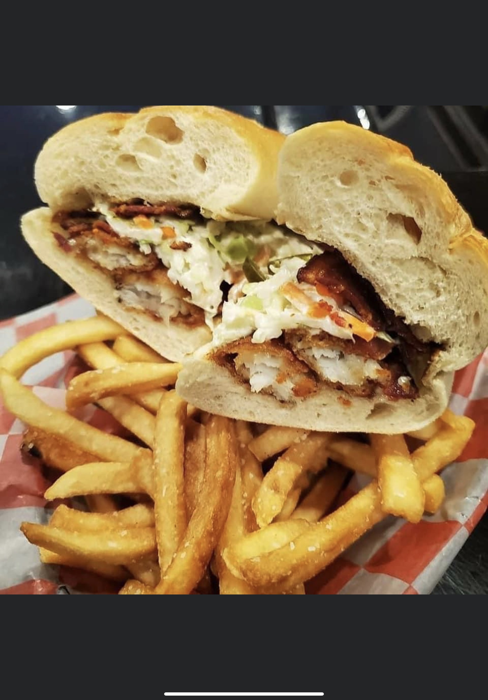 a close up of a sandwich and fries