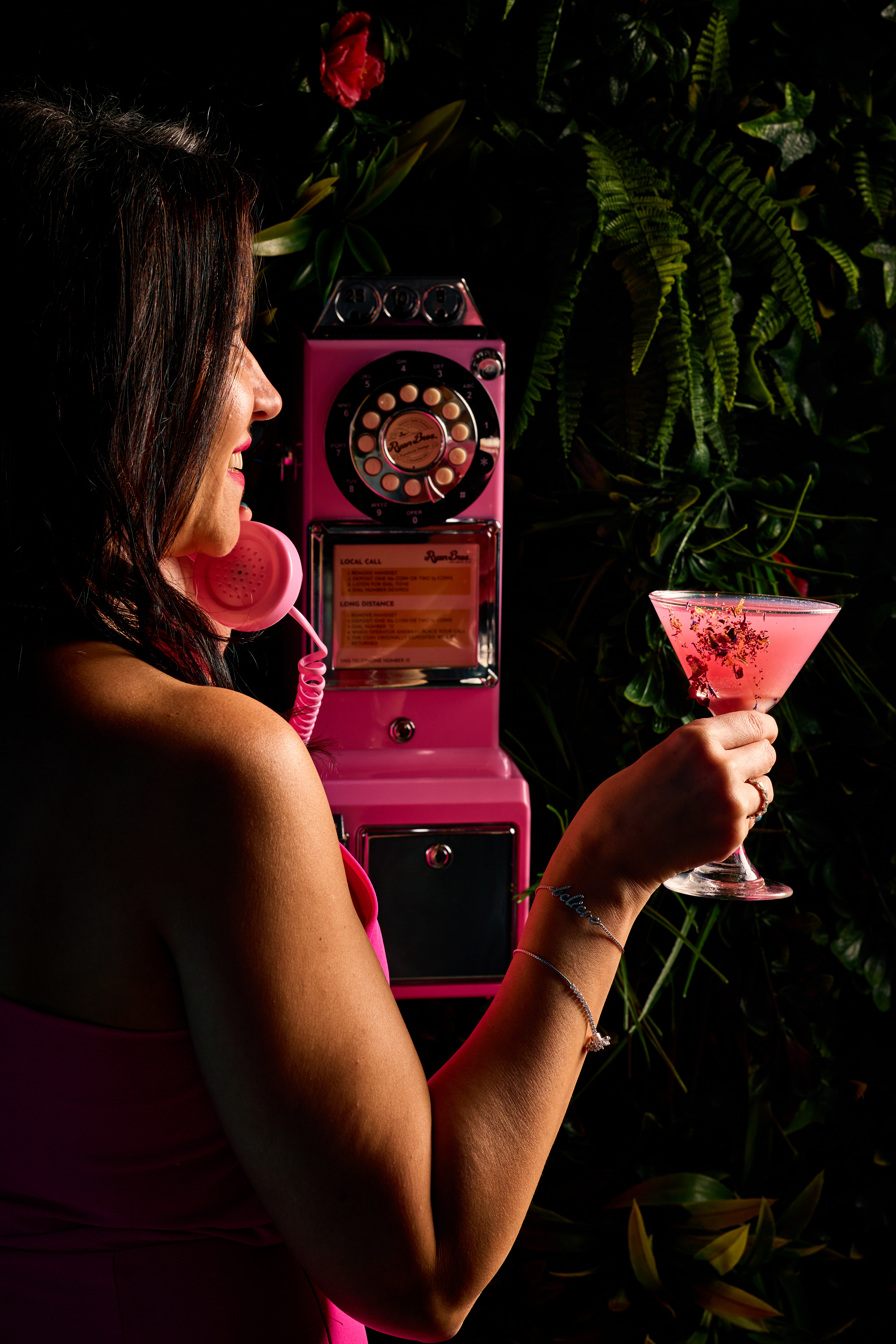 a woman holding a pink telephone