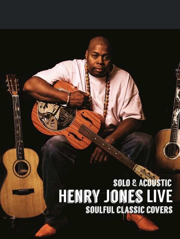 Henry Jones holding a guitar