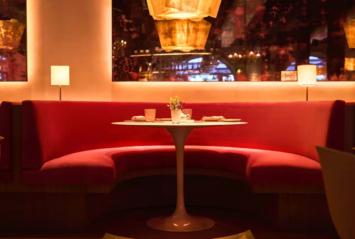 a hotel room with a couch and a table