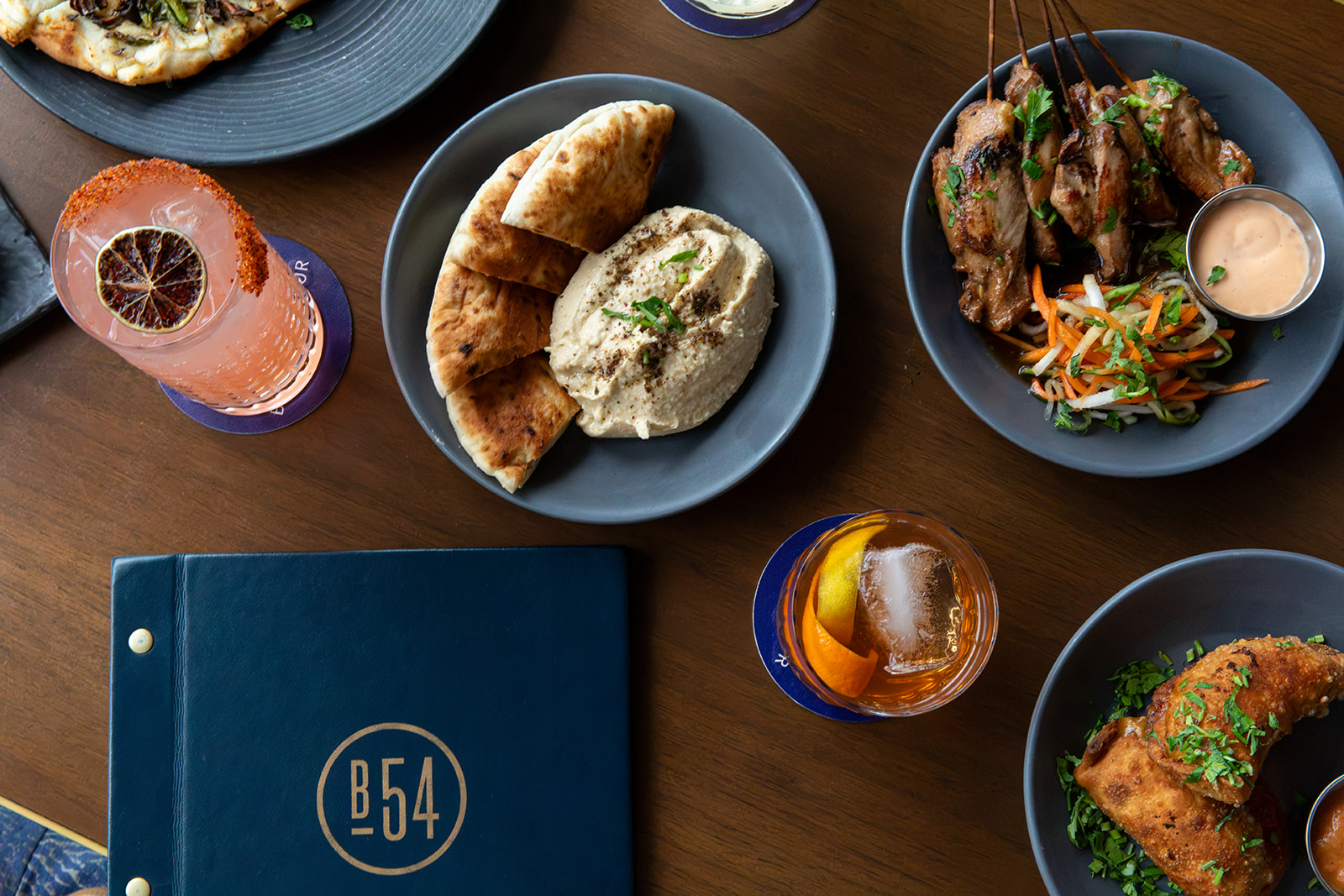 a table with plates of food and drinks