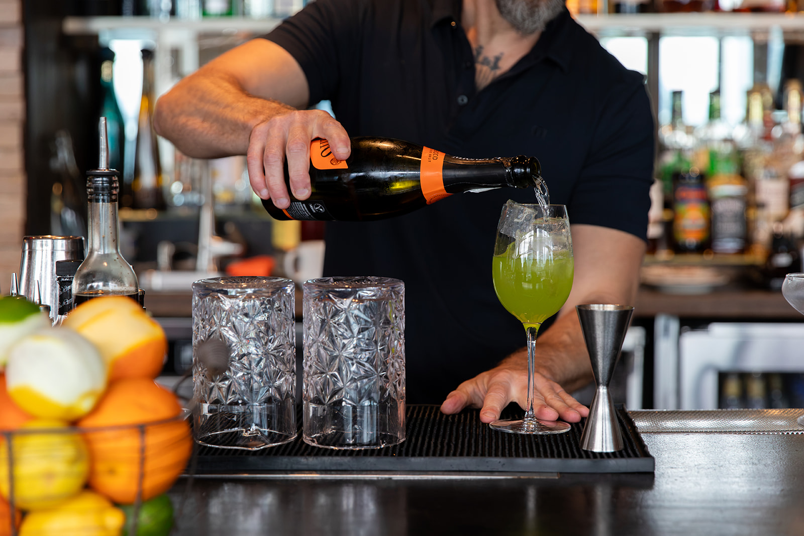 a man pouring a drink into a glass