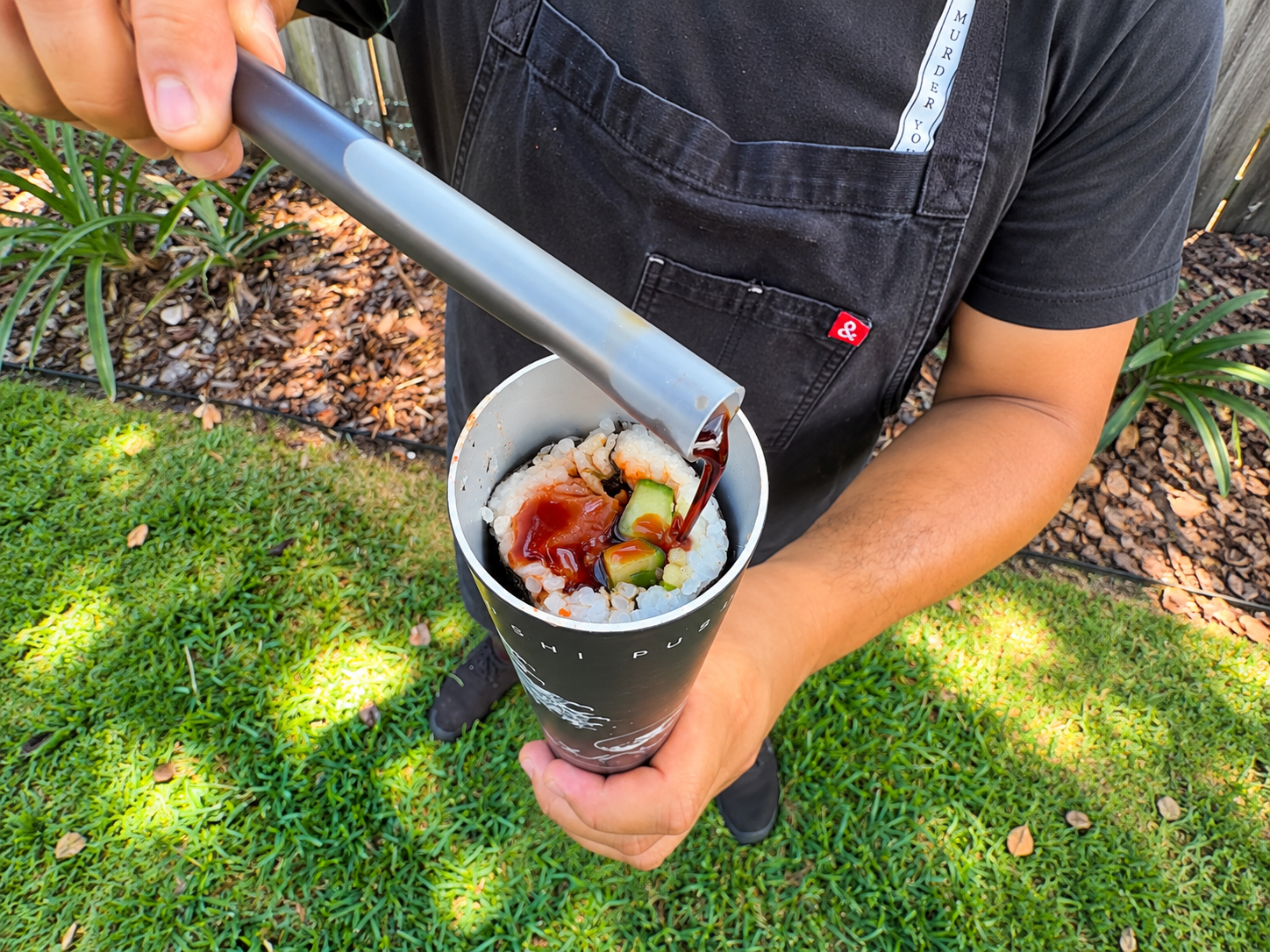 a person holding a cup of sushi