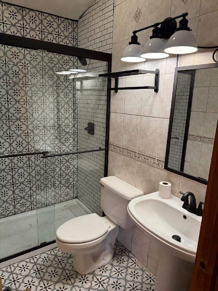 a shower that has a sink and a mirror