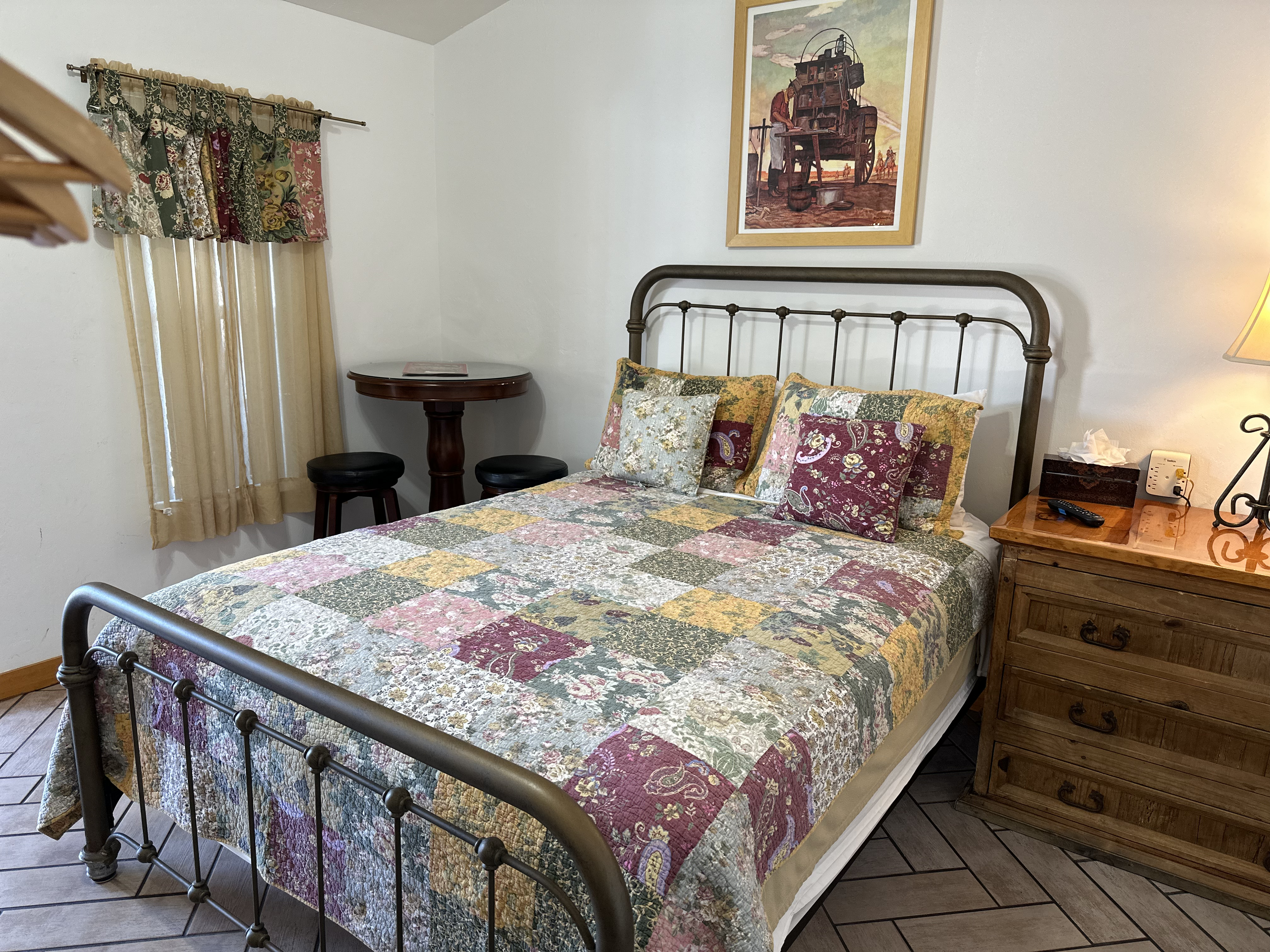 a bedroom with a bed and a chair in a room