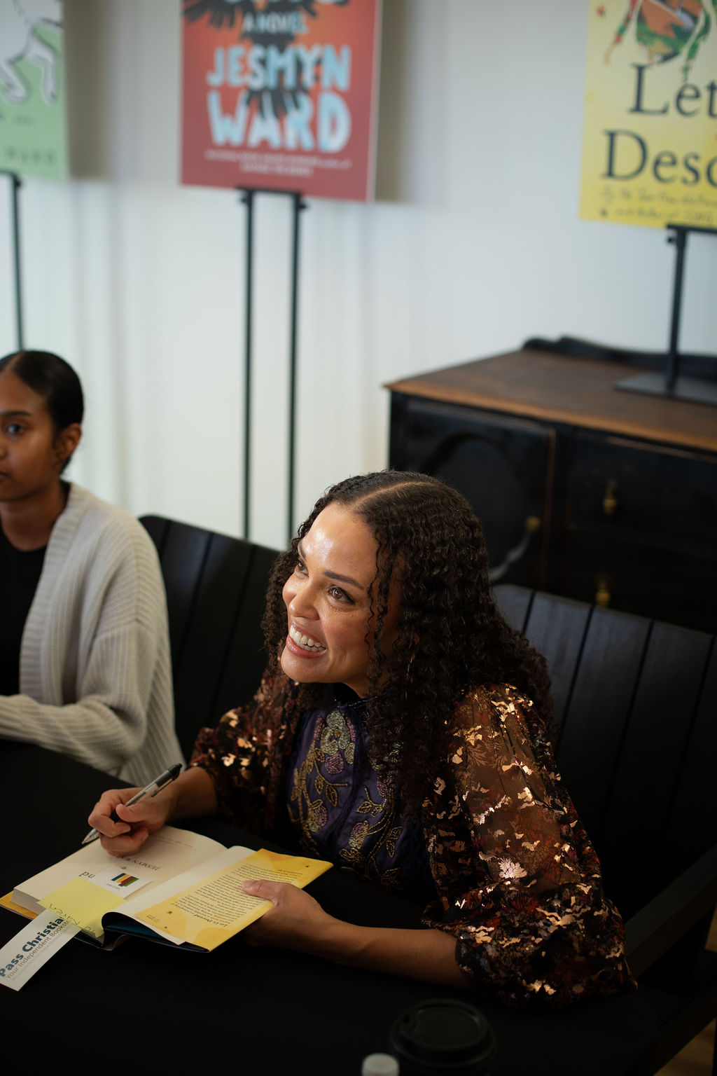 Jesmyn Ward sitting at a table