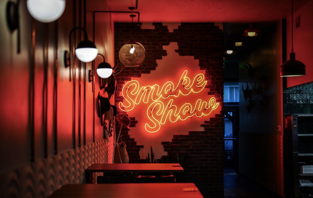 Interior Smoke Show neon sign lit up
