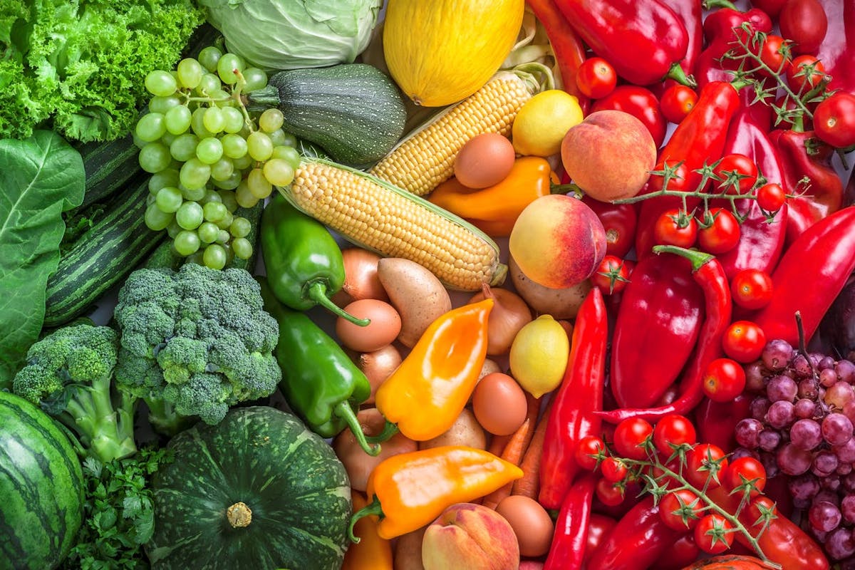 a pile of fresh fruit and vegetables on display