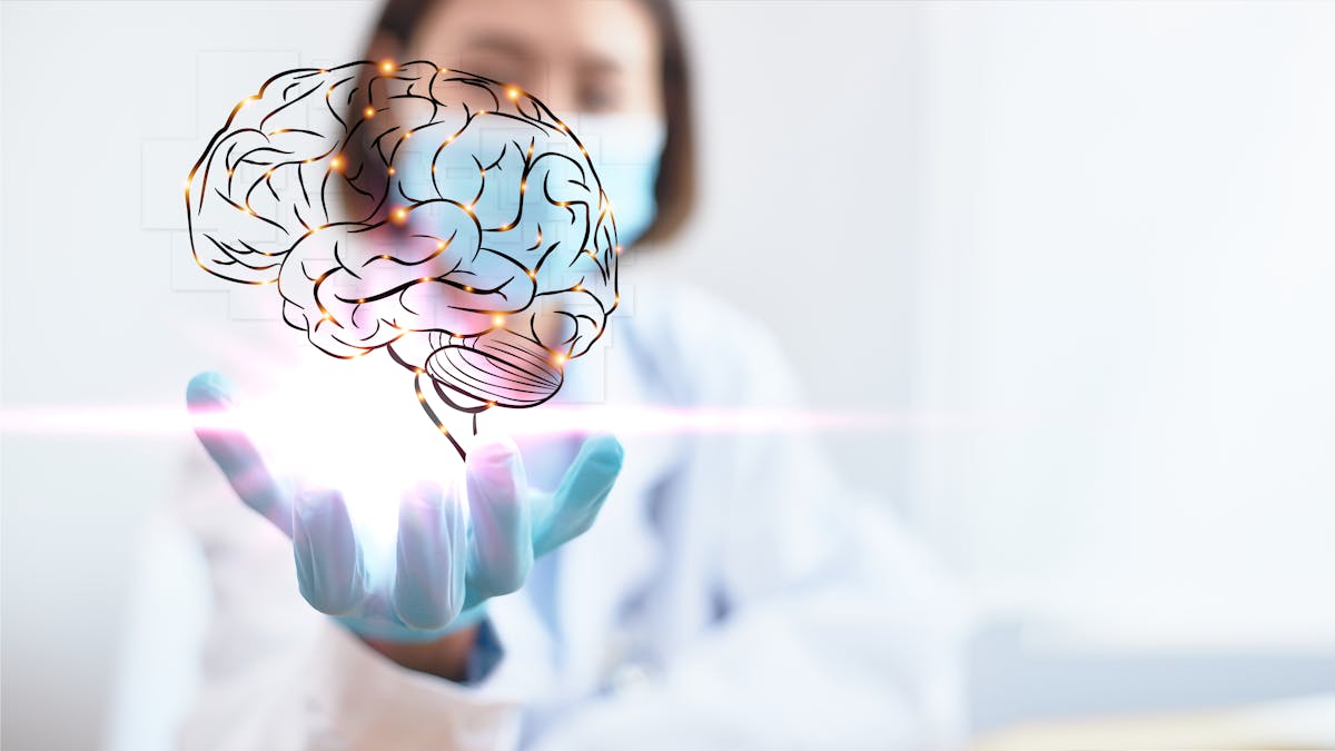 The professional physician opens his hand and has a brain graphic in palm. Medical concept of increasing blood flow to brain for optimal brain health.