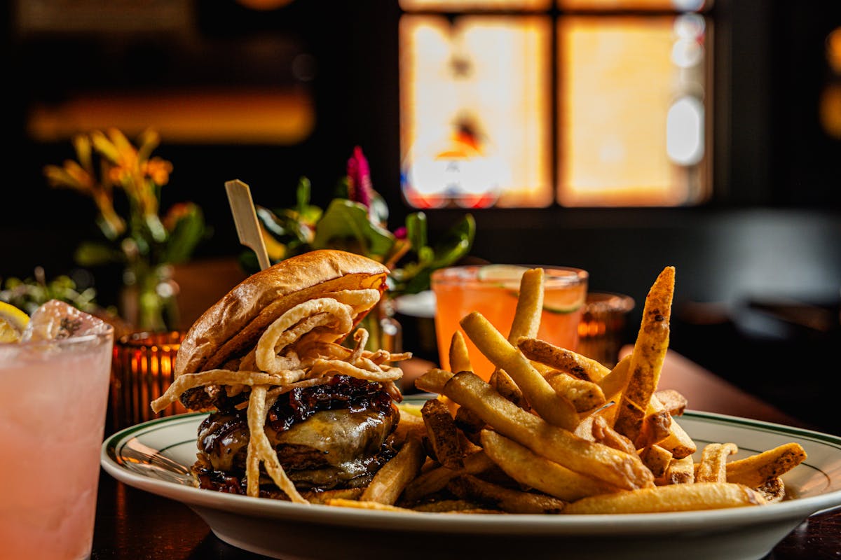 a plate of food with a sandwich and fries on a table