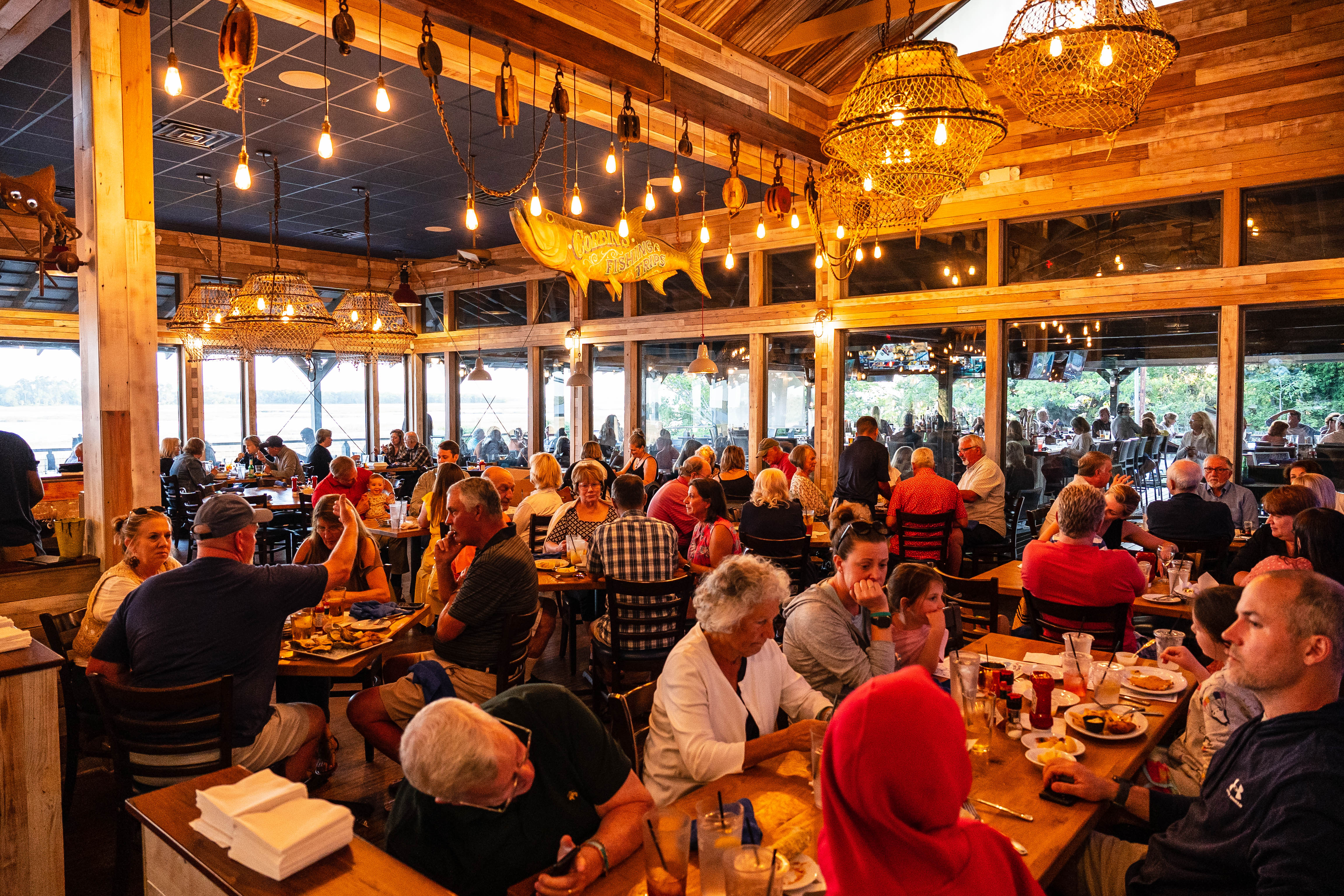 a group of people sitting at a table in a restaurant