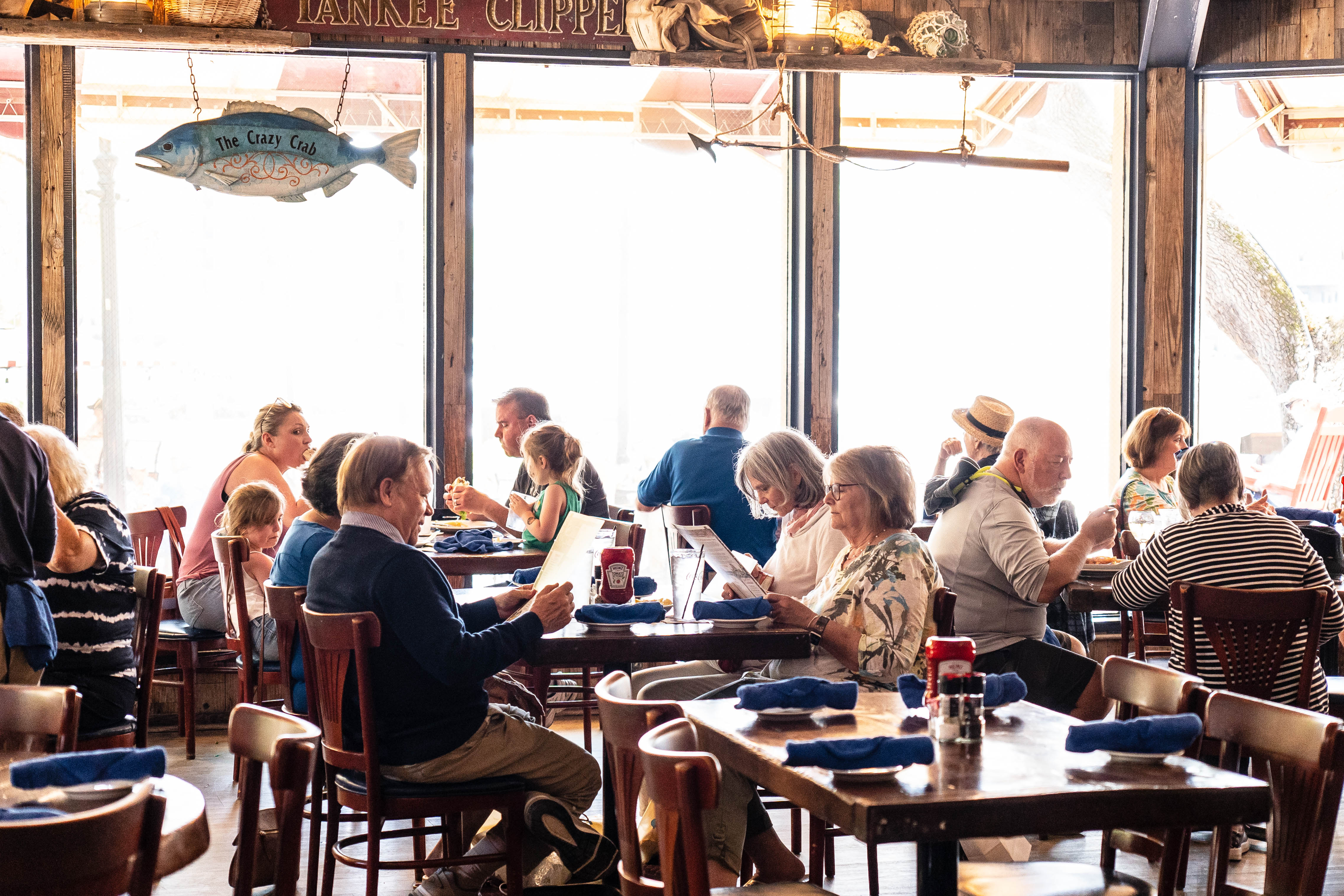 a group of people sitting at a table in a restaurant