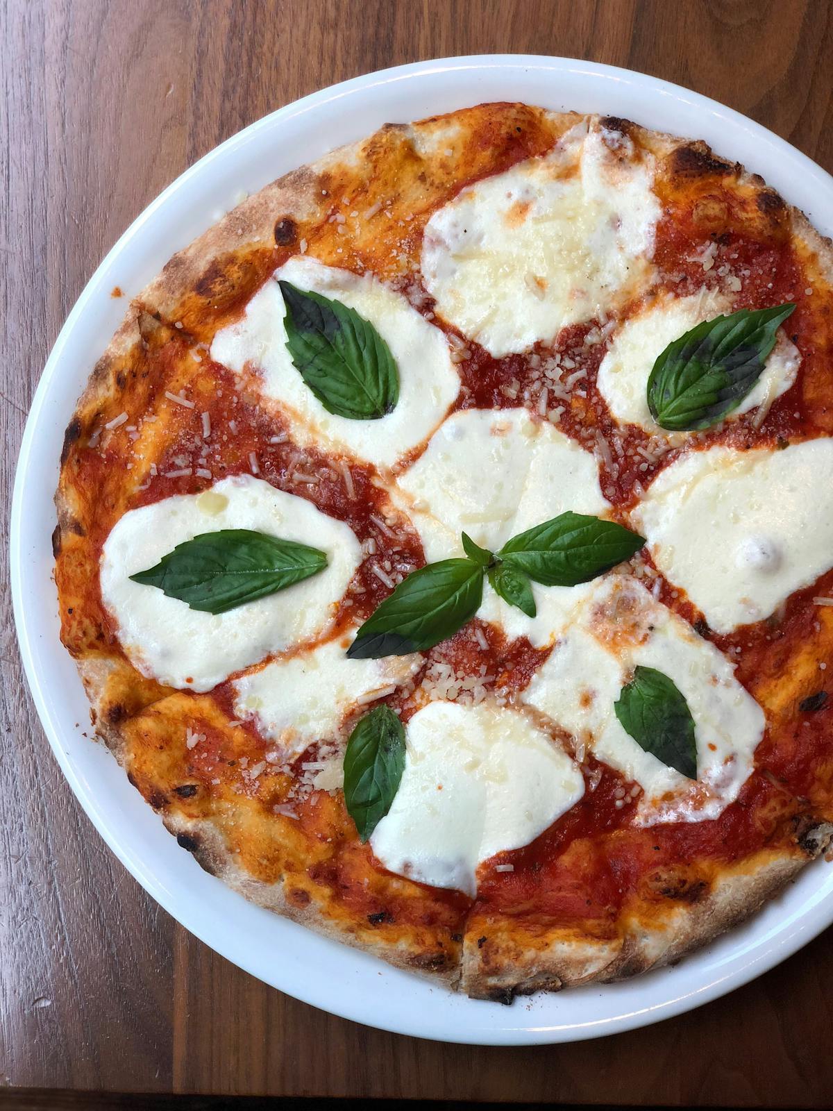 a pizza sitting on top of a plate of food