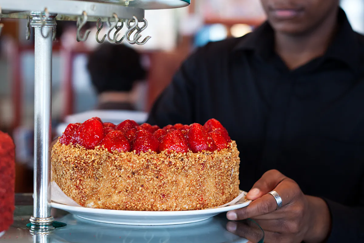 A strawberry-almond cake carried through the dining room