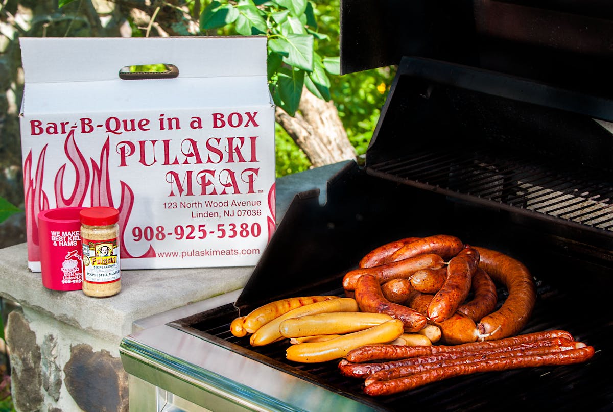 a bunch of hot dogs on a grill