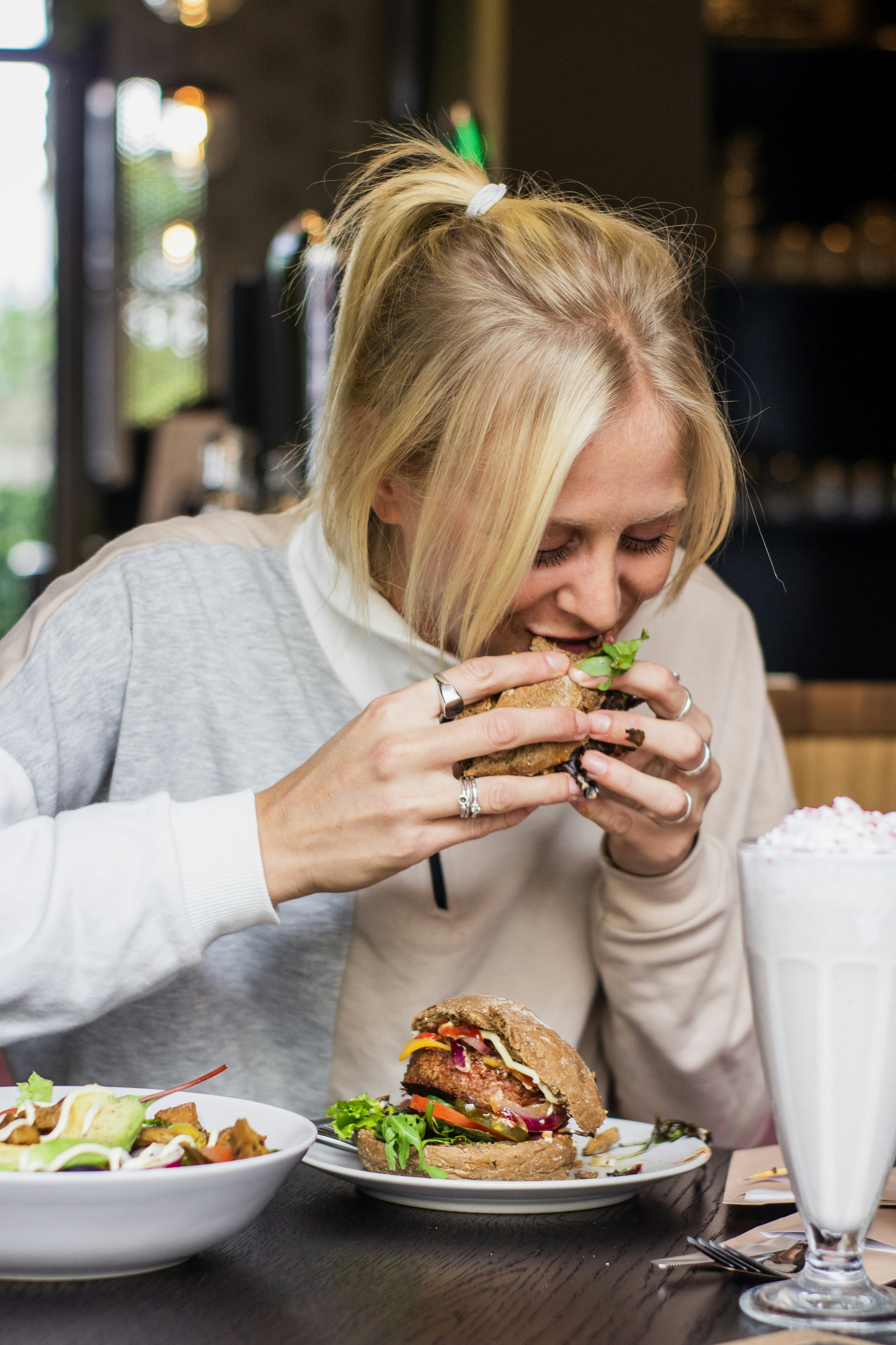 a woman sitting at a table eating food