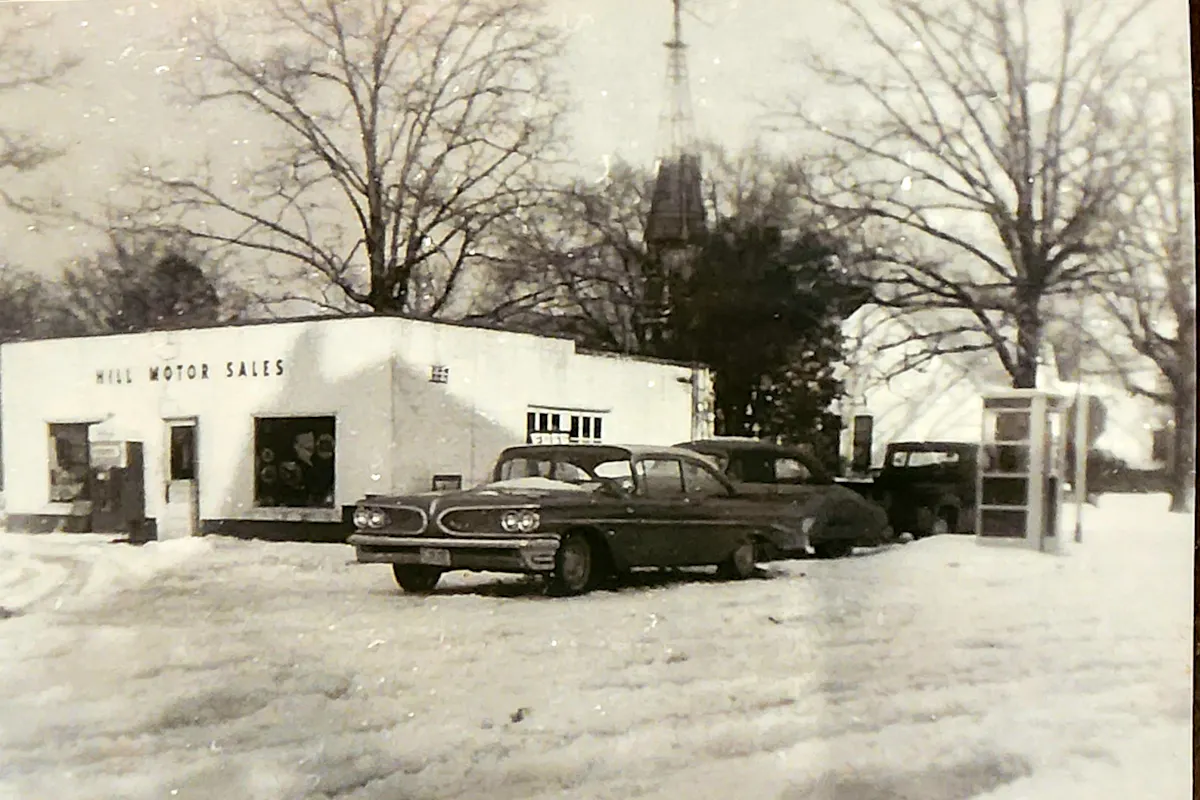 a car parked in a parking lot covered in snow