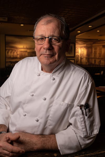 a man wearing glasses and a white shirt