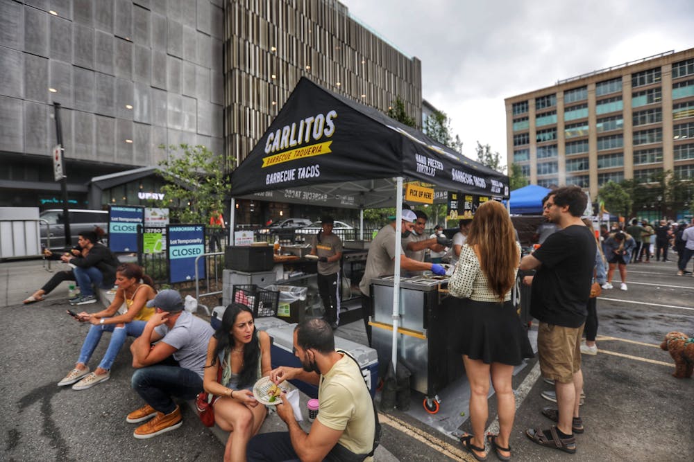 a group of people walking on a city street