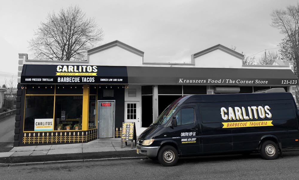 a yellow and black truck parked in front of a building