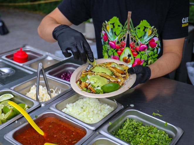 a person sitting at a table with a bowl of food
