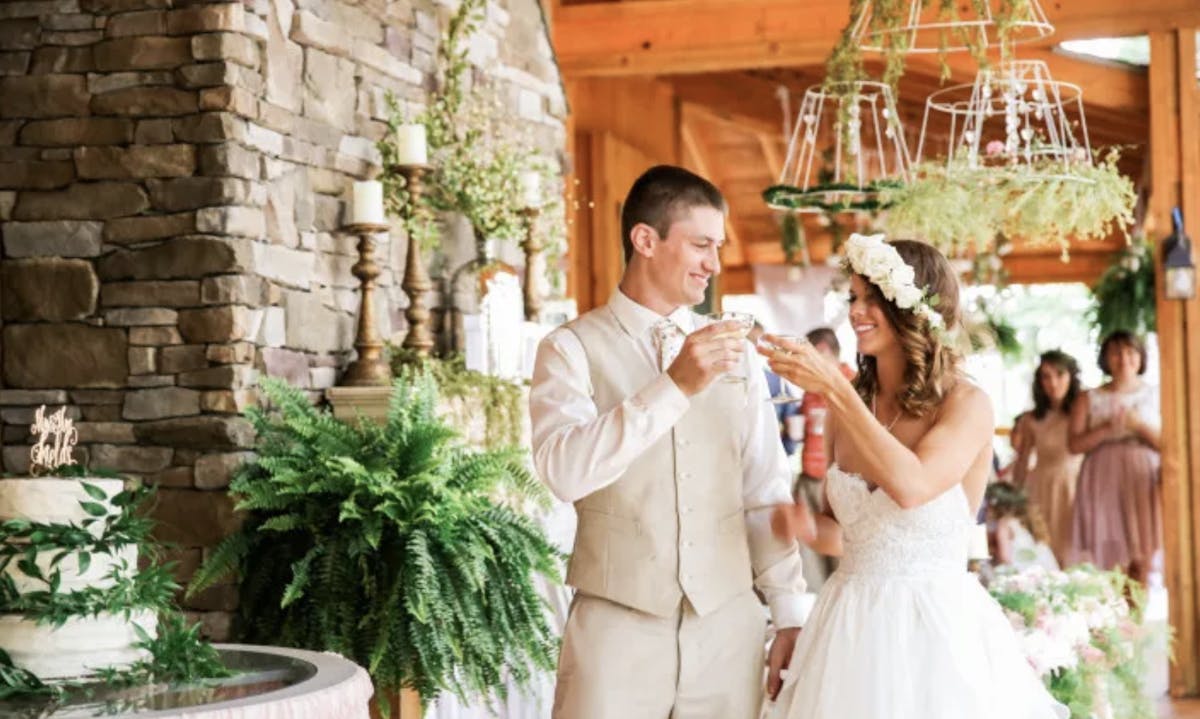 a man and a woman standing in front of a wedding cake