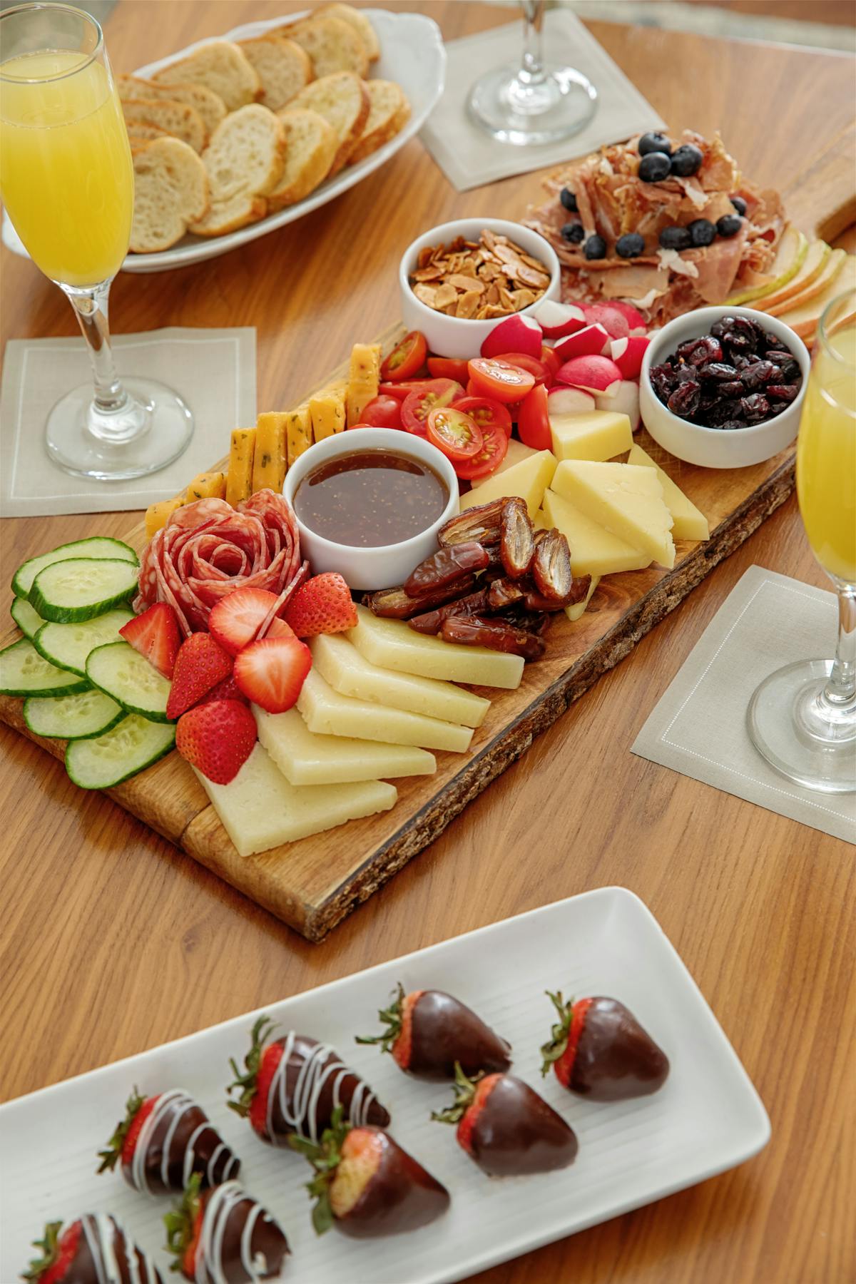 a wooden table topped with plates of food on a plate