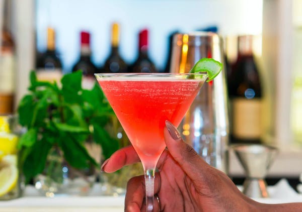 a close up of a person holding a wine glass