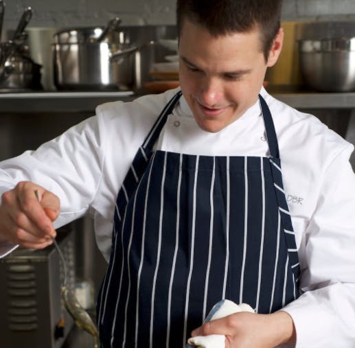 a man preparing food in a kitchen