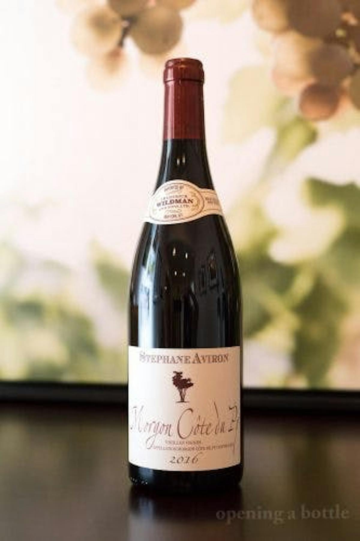 a close up of a bottle and a glass of wine