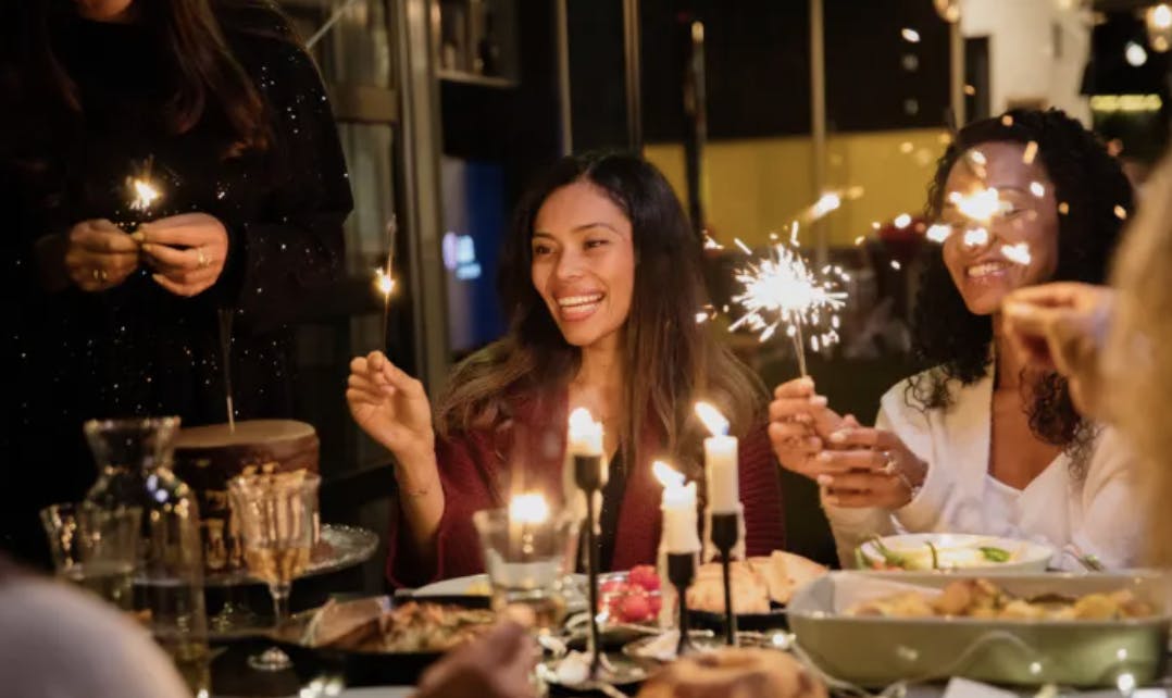 a group of people sitting at a table with wine glasses