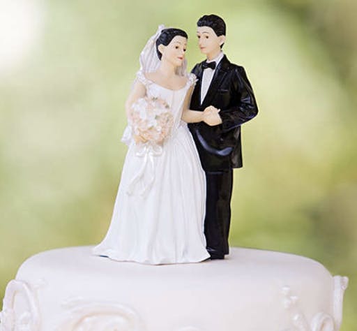 a person standing in front of a wedding cake