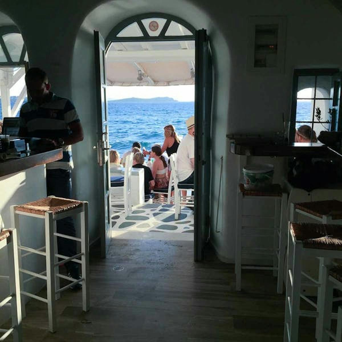 a group of people sitting at a table in front of a window