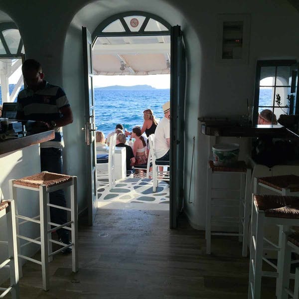 a group of people sitting at a table in front of a window