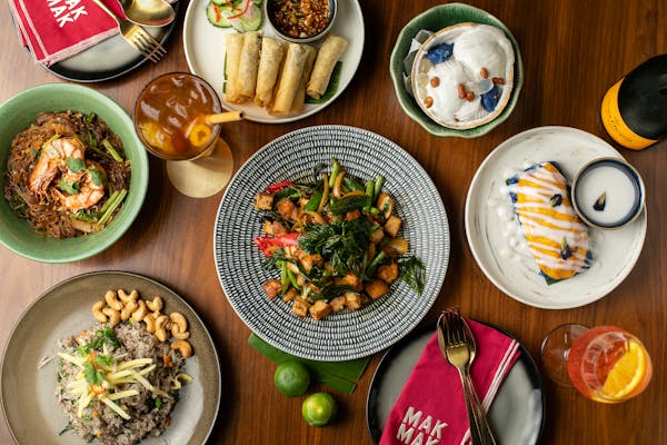 a wooden table topped with plates of food on a plate