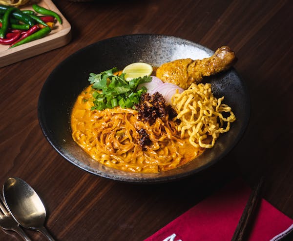 a bowl of food sitting on top of a wooden table