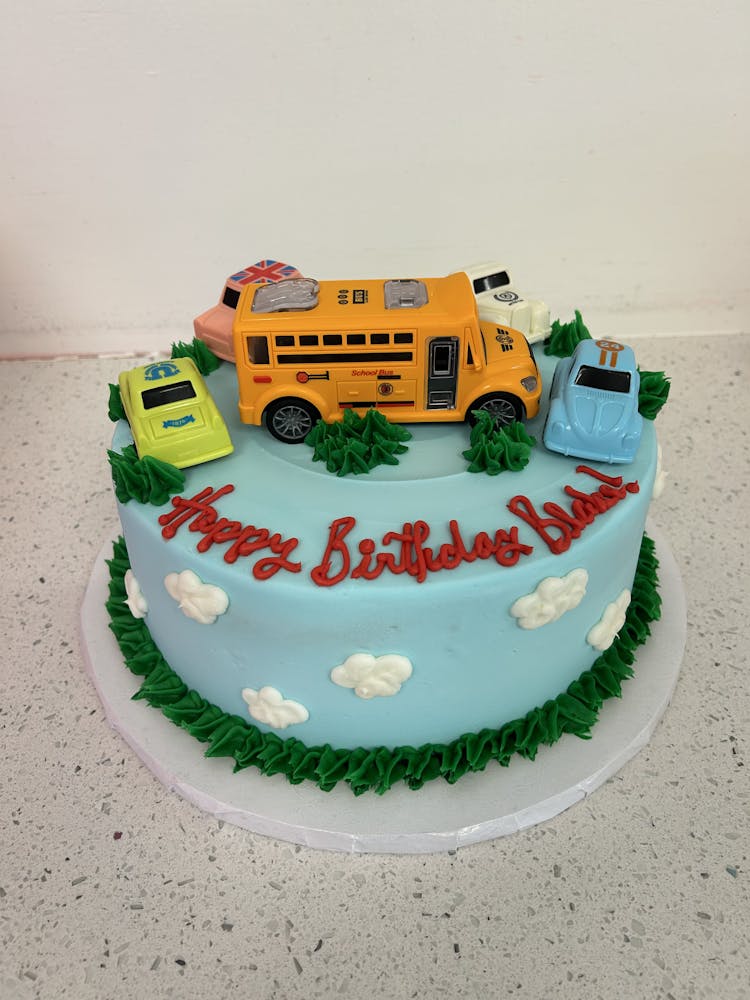 a train cake sitting on top of a car