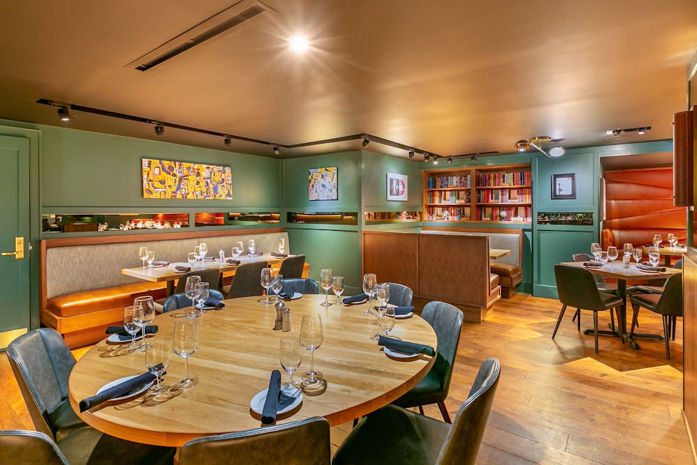 a large commercial kitchen with a table in a restaurant