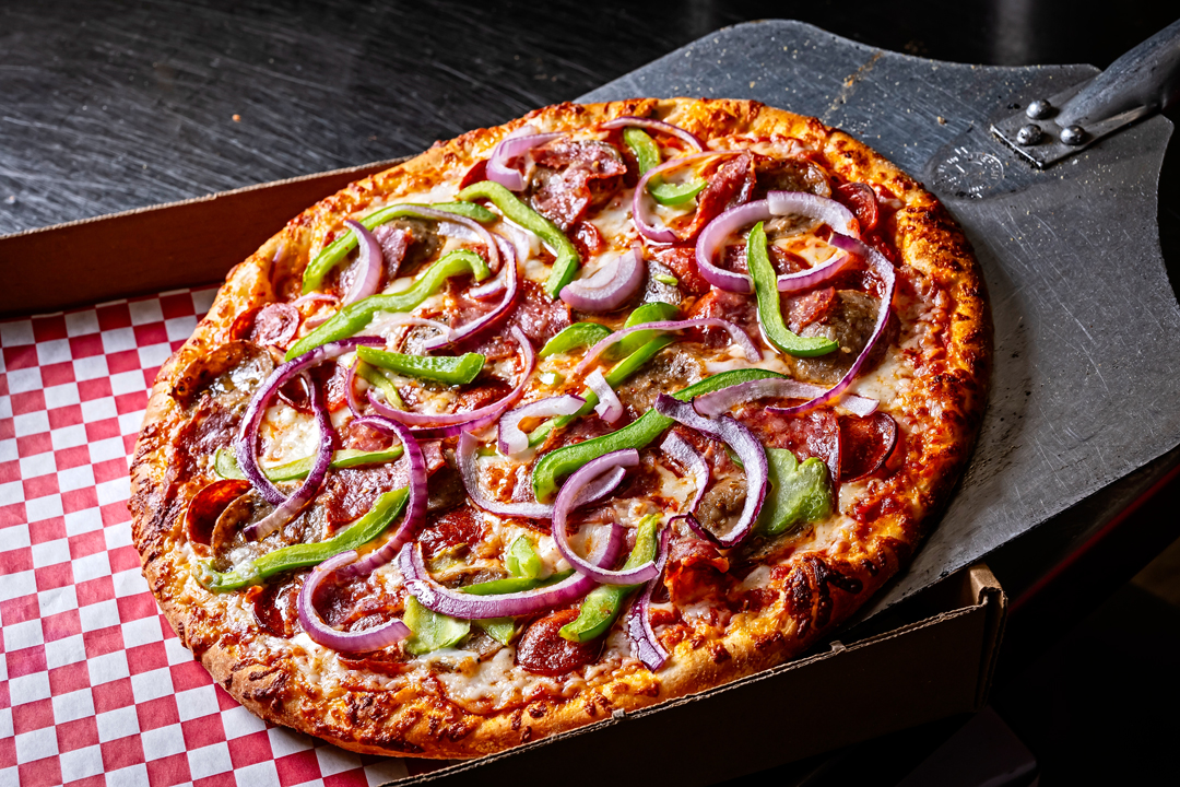 a pizza sliding off a pizza peel