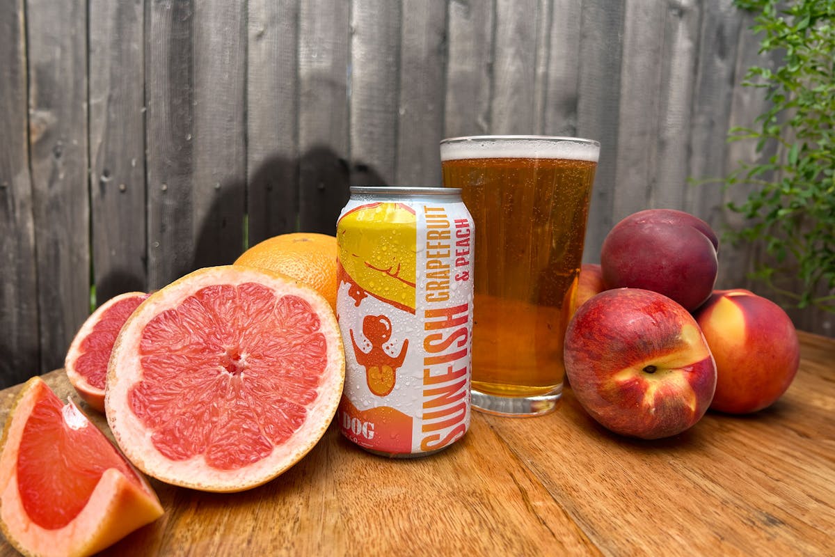 two oranges sitting on top of a wooden table