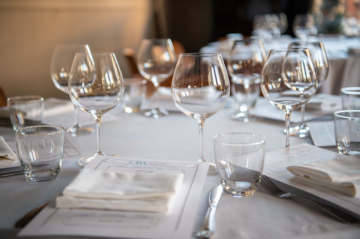 a dining table filled with wine glasses