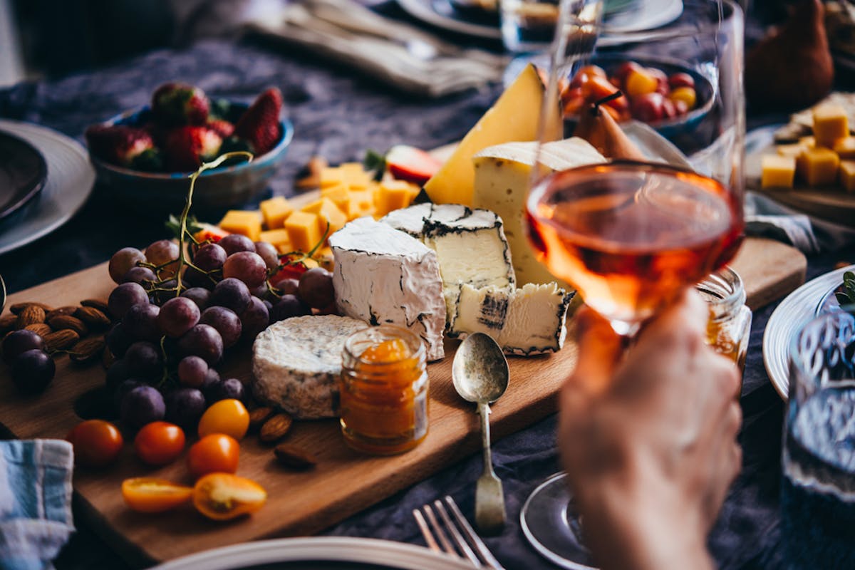 friends having cheese and wine