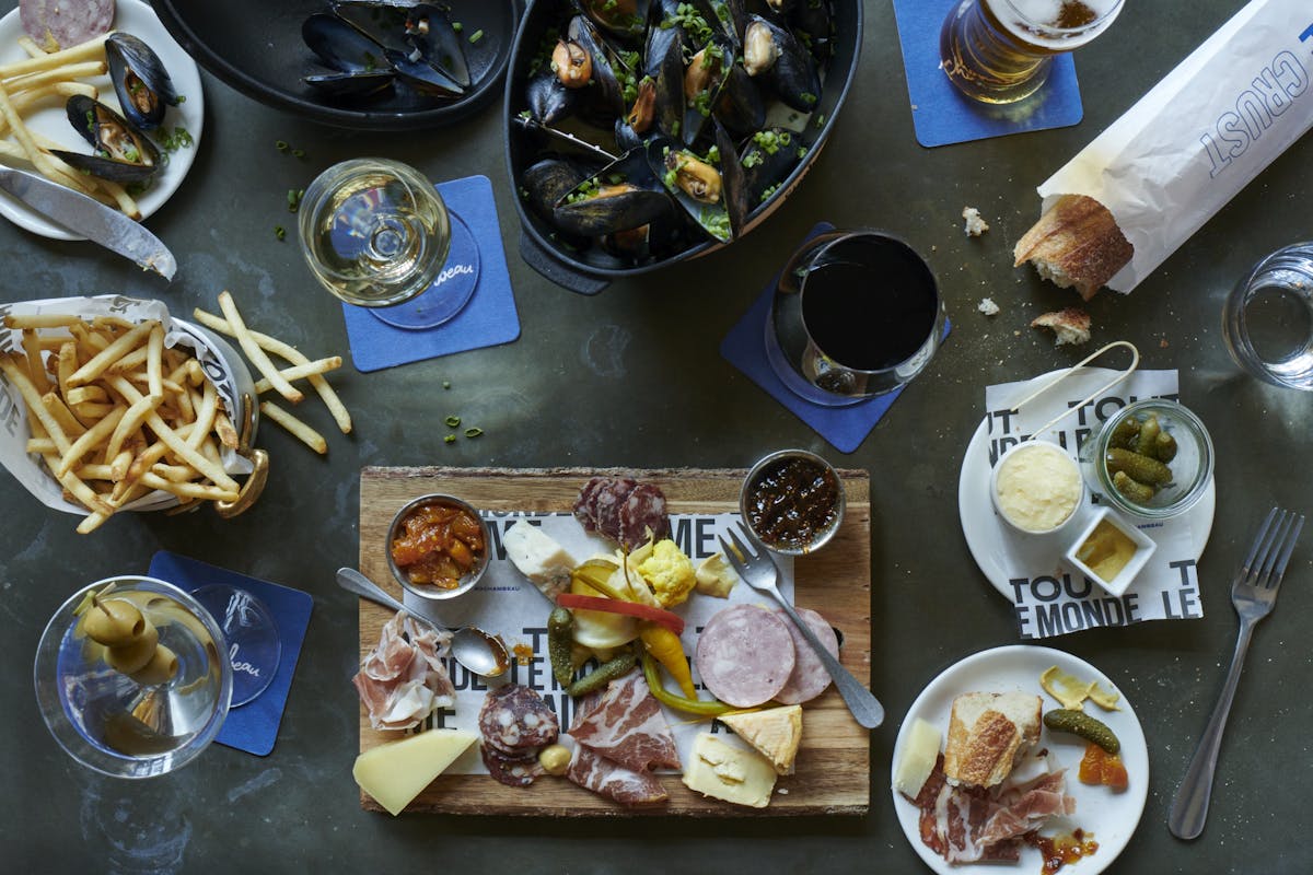 a group of people sitting at a table with a plate of food