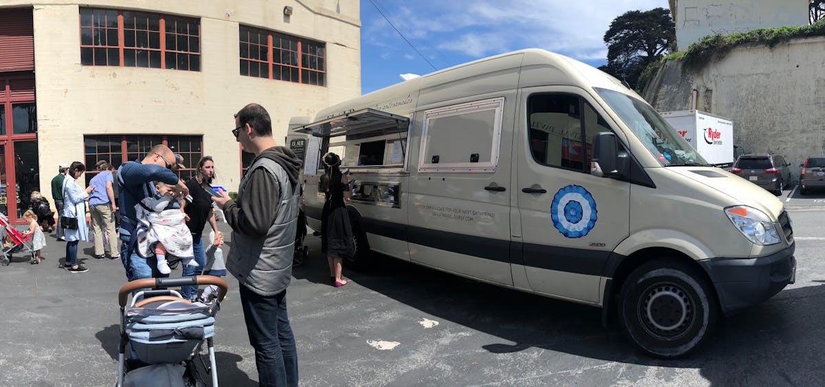 a group of people standing in front of a van